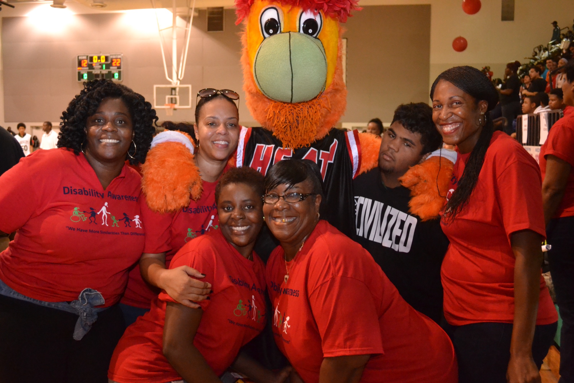 Community event participants with mascot