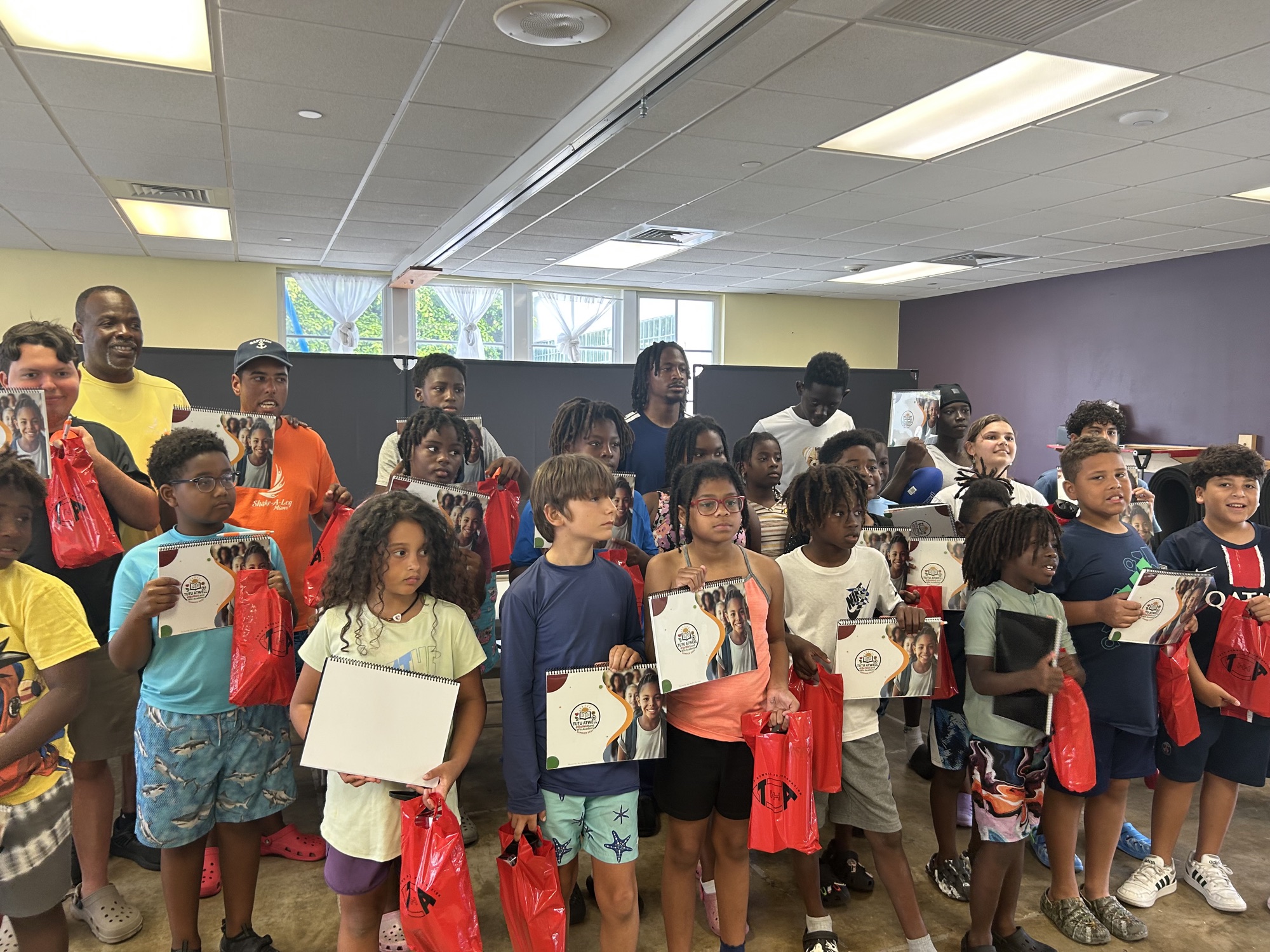 Youth program participants holding program materials
